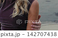 Tender urban embrace, Warm affectionate gesture in city environment, Softly lit scene capturing emotional closeness amidst urban crosswalk setting 142707438