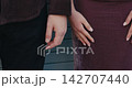 Intimate hands embrace, Fleeting romantic instance showcasing hands in tender contact amidst warm textured environment 142707440