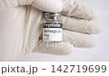Gloved hand holding an Semaglutide peptide vial 142719699