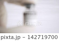 Gloved hand holding retatrutide peptide vial for medical research 142719700