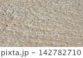 Natural Texture of Sandy Beach Captured Under Bright Sunlight 142782710