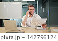 Businessman Discussing Project Details During Office Phone Call 142796124