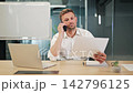 Businessman Discussing Important Documents During Phone Call 142796125