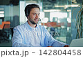 Smiling Help Desk Agent Wearing Headset During Online Call 142804458