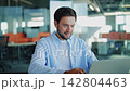 Male Software Developer Working on Laptop in Modern Office 142804463