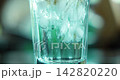 Macro close up pouring thick green matcha tea over ice cubes in a clear glass. Cinematic slow motion of refreshing cold summer beverage preparation. Iced green tea latte swirl background 4K video. 142820220