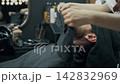 Barber Applying Hot Towel to Client's Face 142832969