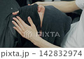 Barber Applying Hot Towel to Client's Face 142832974