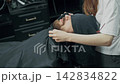 Barber Wiping Client's Beard After Haircut 142834822