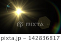 A striking scene showing a bright sun shining with a lens flare effect against a dark sky landscape, creating a vivid contrast and dramatic natural lighting. 142836817