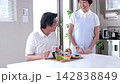 A senior man being served meals at a nursing home and a senior female staff member. 142838849