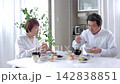 A senior couple eating a meal in the dining room. 142838851