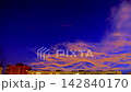 Clouds at dusk lit by bright evening sunlight in town 142840170
