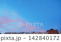 Morning sunrise with clouds moving above apartment blocks 142840172