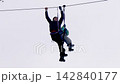 People ride at adventure ropes and zipline park in winter 142840177