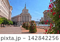Sofia, Bulgaria - 10.09.2026, Front architectural view of the National Assembly, former Communist Party House, red flower bushes along the road. 142842256