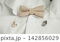 Wedding day details with bow tie and cufflinks displayed on a white dress shirt 142856029