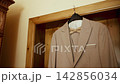 Wedding attire hangs on a hanger in preparation for the special day at a venue 142856034