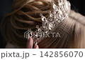 Bride prepares for wedding day with tiara in hair 142856070