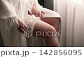 Moment of preparation on a wedding day in a bright room with flowing curtains 142856095