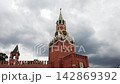 Low angle view of historic Spasskaya clock tower in Moscow against a grey overcast sky 142869392