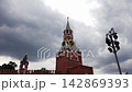 Low angle view of historic Spasskaya clock tower in Moscow against a grey overcast sky 142869393