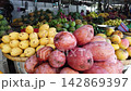Panning shot of a colorful tropical fruit display at a vibrant outdoor market stall 142869397