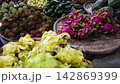 Camera pans across vibrant display of exotic tropical fruits at local street market 142869399
