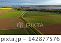 Wide horizontal aerial drone video of agricultural fields, irrigation canals, Veerse Meer lake, green islands, and polder landscape near Ruiterplaat, Zeeland, Netherlands on sunny evening 142877576