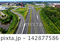 Wide horizontal aerial drone video of multi-lane highway interchange, asphalt roads, traffic ramps, office park buildings, and green tree landscape in Leiden, South Holland, Netherlands 142877586