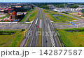 Wide horizontal aerial drone video of multi-lane highway overpass, traffic interchange, Corpus museum landmark, office park, and green landscape in Leiden, South Holland, Netherlands on sunny day 142877587