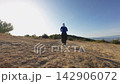 Trail running woman determined solo athlete handheld tracking shot 142906072
