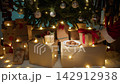 Santa Claus places gifts under the tree 142912938