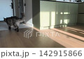 Older maine coon cat walks slowly through home interior on wooden floor. Large fluffy feline moves calmly across room in everyday domestic scene. Pet aging movement and lifestyle concept.. 142915866