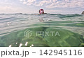 Young happy Woman in white bikini snorkels in the sea with a pink mask. Positive smiling woman relaxing and enjoying water activities with family summer travel holidays vacation on sea. 142945116