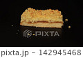 Chef Hands Lifting Fresh Apple Crumble Cake Slice from Black Background 142945468