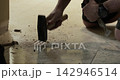 Construction worker replacing tile floor 142946514