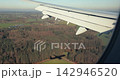Airplane landing view of aircraft shadow on the ground 142946520