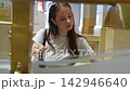 Young woman counting floors on an art deco elevator indicator 142946640