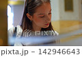 Young student searching for a book in a public library 142946643