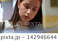 Young woman concentrating on her work indoors 142946644