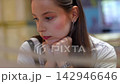 Thoughtful young woman reflecting and looking at camera 142946646