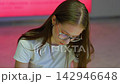 Young student with glasses focusing on writing or drawing 142946648
