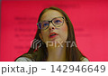 Young female student with glasses thinking and drawing on tablet 142946649