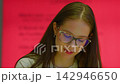 Young student with glasses studying thoughtfully 142946650