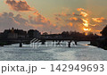 Italy Pisa city bridge over Arno river at sunset. 142949693