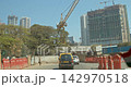 Mumbai, India. Traffic in center street. Multi-storey Houses in residential district. Cars Moving On Street In day. POV inside car. Construction site area. Development Multistorey Residential Building Mumbai, India. Traffic in center street. Multi-storey Houses in residential district. Cars Moving On Street In day. POV inside car. Construction site area. Development Multistorey Residential Building 142970518