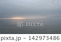 朦朧的地平線和柔和的陽光照亮了平靜的大海——這幅自然景象展現了嶄新的未來和寧靜祥和。 142973486