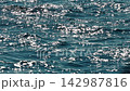 sun reflection on water surface at sunny day, blue color, crystal clear azure water, waves 142987816
