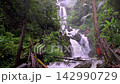 Scenic Huai Nam Yen Waterfall cascading through lush tropical rainforest in the rainy season in Omkoi District Chiang Mai, Thailand 142990729